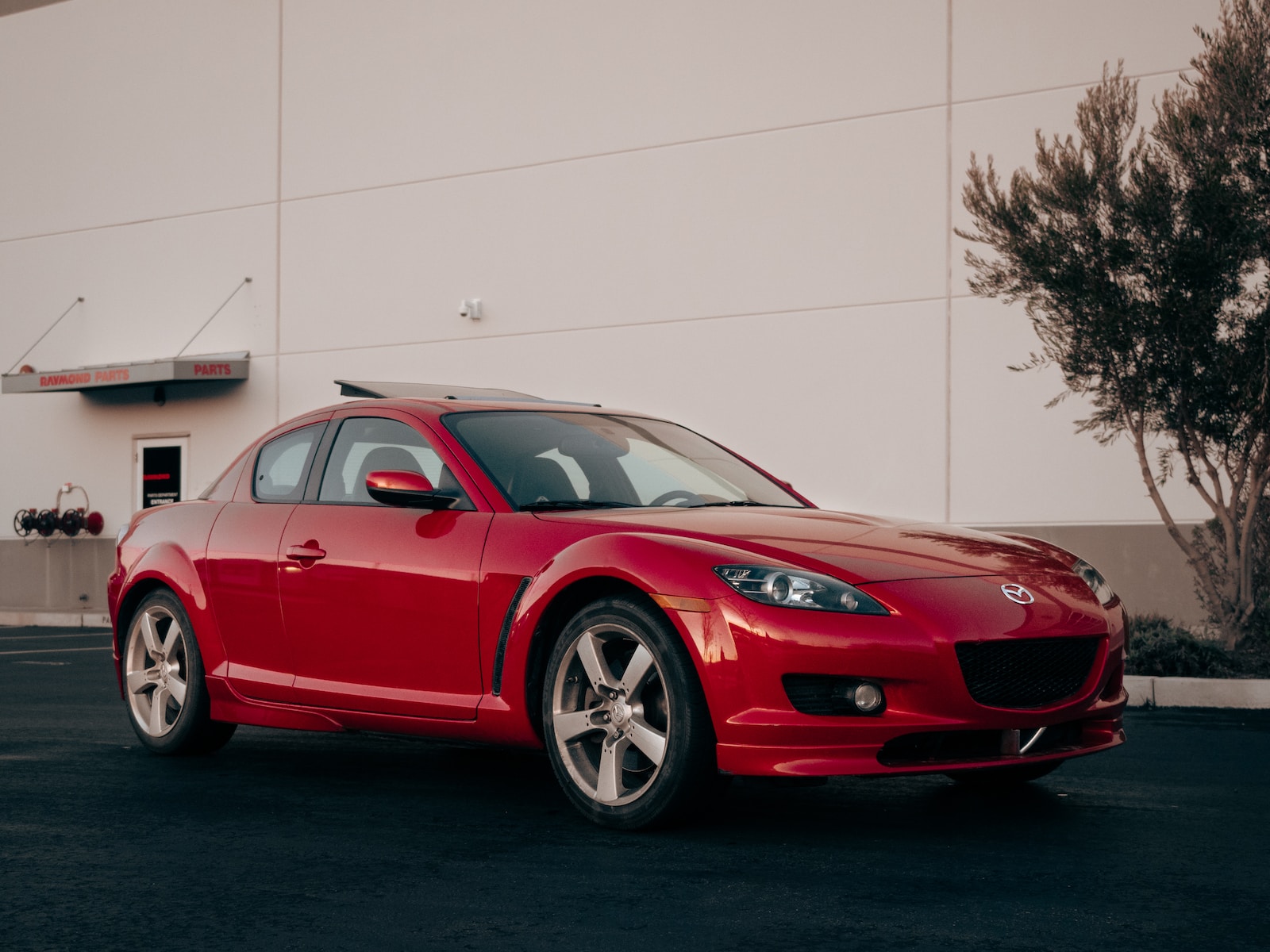 a red sports car parked in front of a building