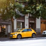 a yellow sports car parked on the side of a street