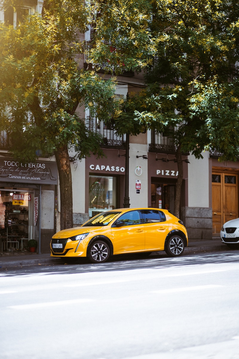 a yellow sports car parked on the side of a street