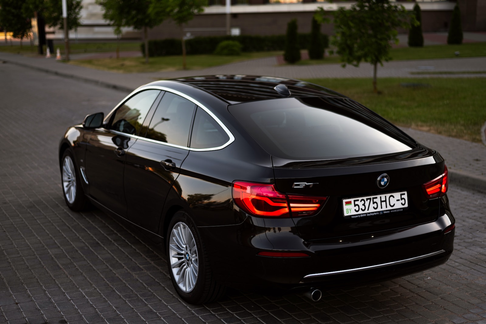 a black car parked on a brick road