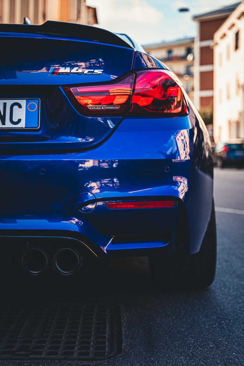 a blue car parked on the side of the road