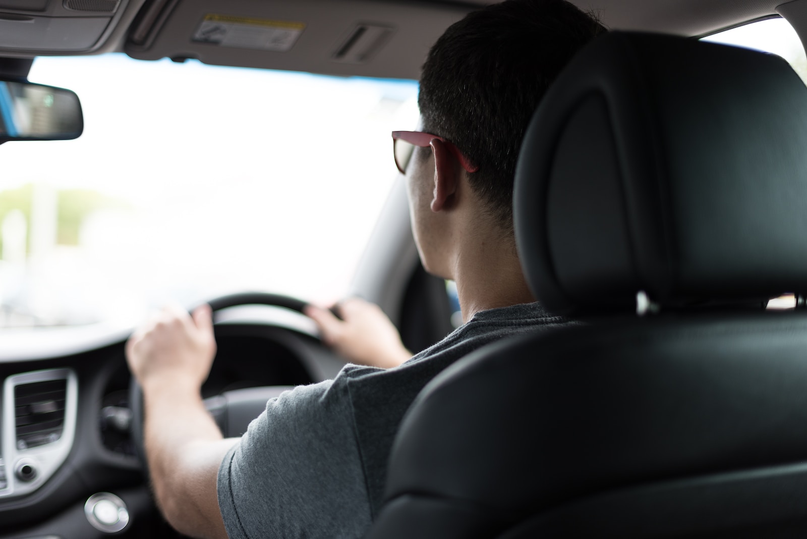 man driving car during daytime