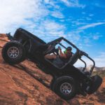 man riding a black off-road vehicle